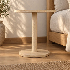 Low view of the SquareSoft travertine side table beside a timber bed.