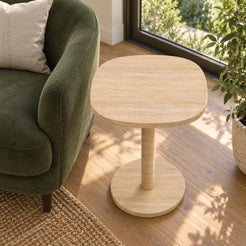 Elevated view of the SquareSoft travertine side table in a garden-facing reading room.