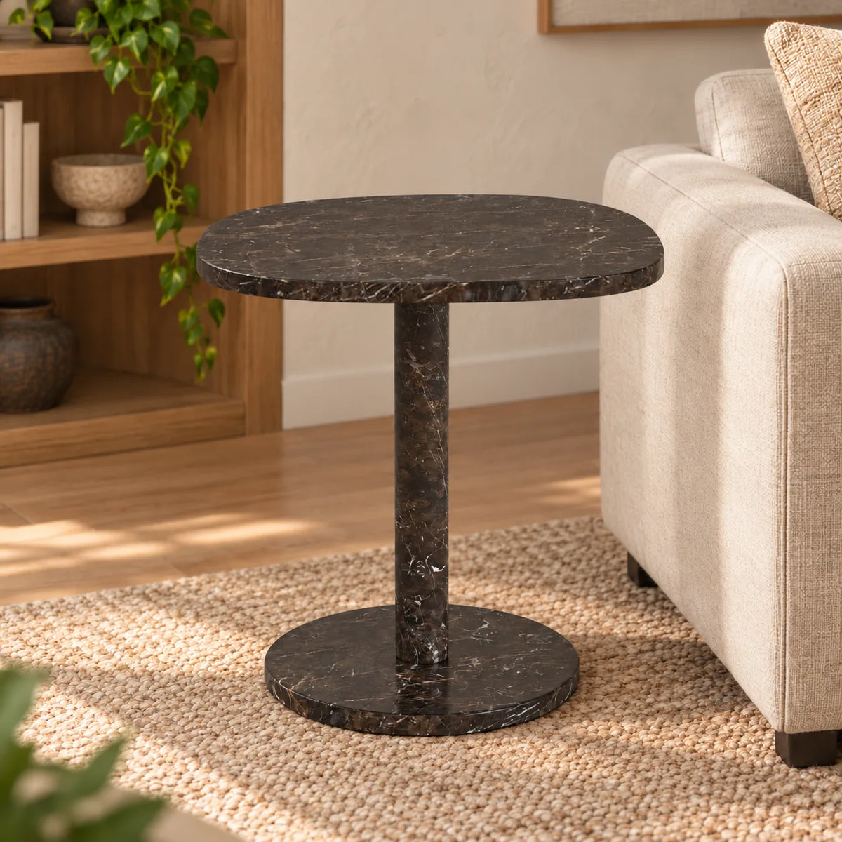 SquareSoft Dark Emperador marble side table with a rounded square top and circular base beside a linen sofa.