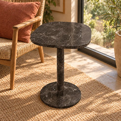 Elevated view of the SquareSoft Dark Emperador marble side table in a window-side reading nook.