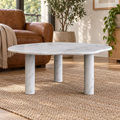 Low frontal view of the SunAura Carrara marble coffee table beside leather reading chairs.