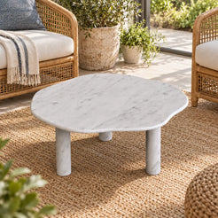 Elevated view of the SunAura Carrara marble coffee table in a garden-window sitting area.