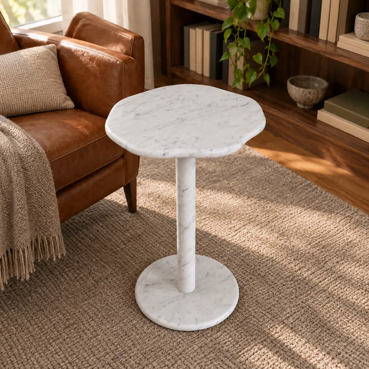SunAura Carrara marble side table in a warm reading corner, shown from a high front view