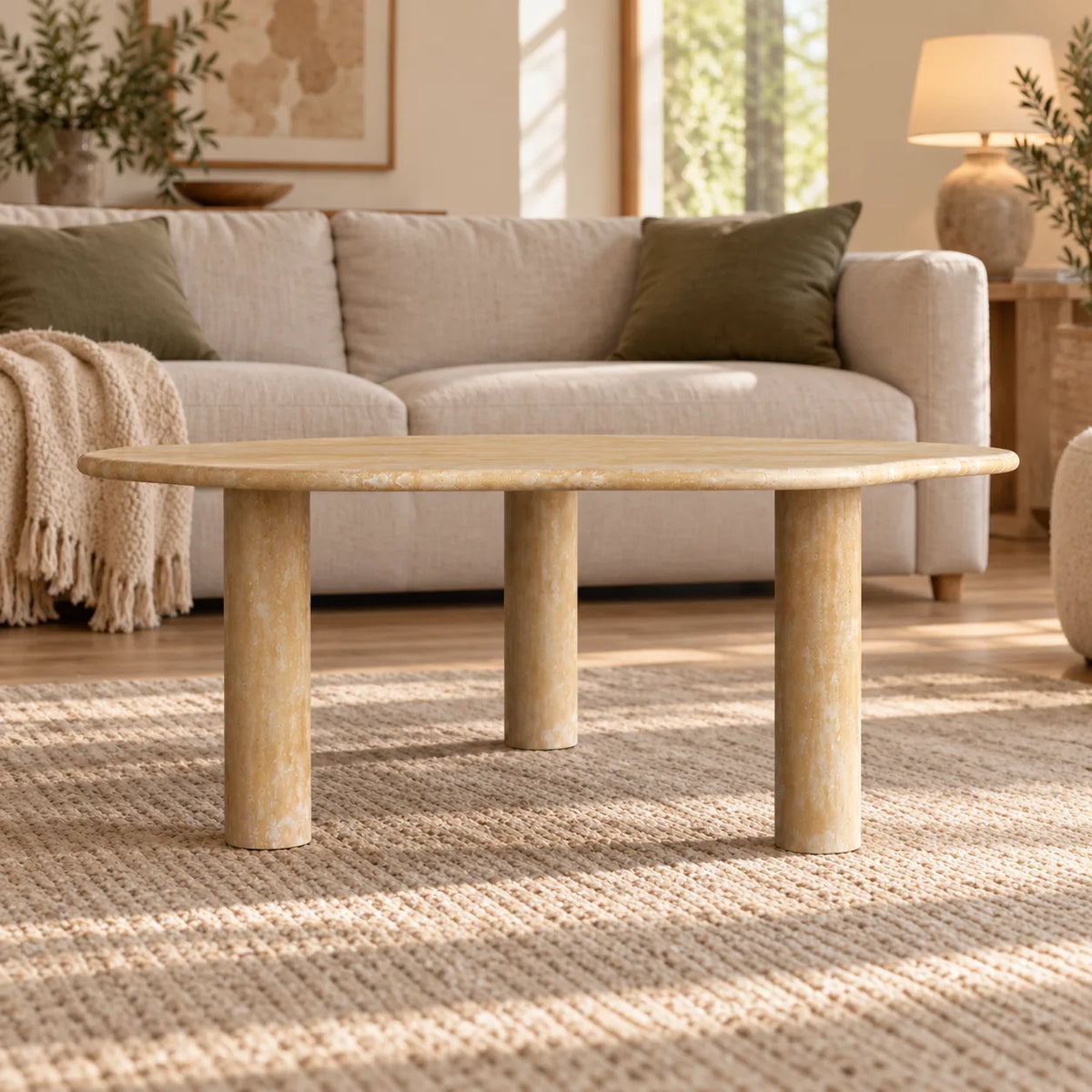 SunAura Classico travertine coffee table in a warm linen-sofa living room, shown from a low front view