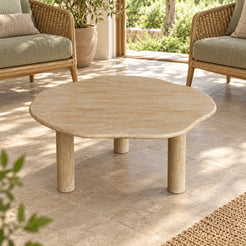 SunAura Classico travertine coffee table in a garden sunroom, shown from a high front view