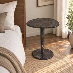 Moderate view of the SwanEgg Dark Emperador marble side table beside a walnut bed.