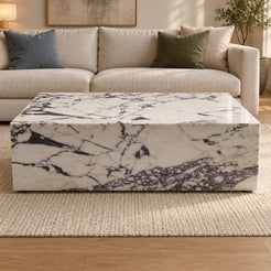 ViolaPlinth Calacatta Viola marble coffee table in a linen-sofa living room, shown from a raised long-side view