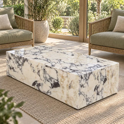 ViolaPlinth Calacatta Viola marble coffee table in a garden sunroom, shown from an elevated front-quarter view